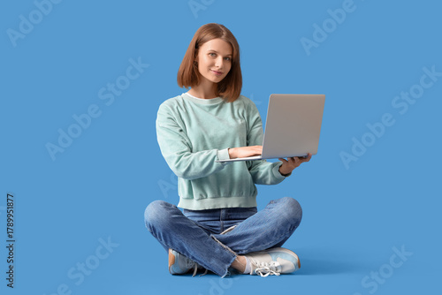 Young woman using laptop on...