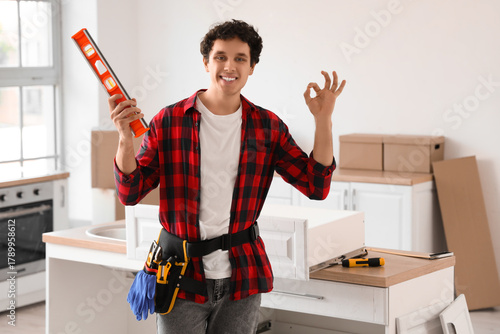 Male worker with level show...