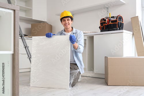 Male worker with shelf asse...