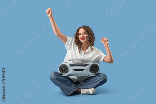 Young woman with boombox li...