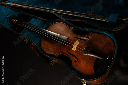 vieux violon posé sur un bel étui ancien de couleur bleu vert.