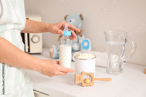 Woman with baby milk formul...