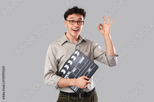 Young man with movie clappe...