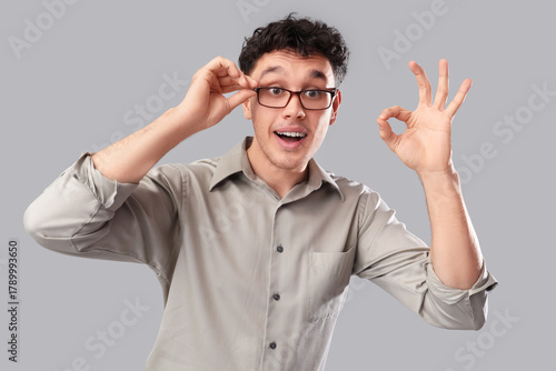 Young man in eyeglasses sho...
