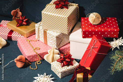 Many Christmas gifts on blue sofa