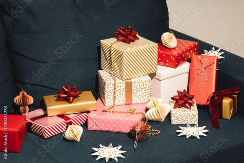Many Christmas gifts on blue sofa