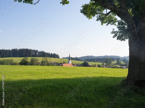 Stiefenhofen, Germany - July 21st 2024: Morning view of the village with church surrounded by hills