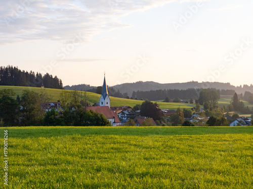 Stiefenhofen, Germany - July 21st 2024: Morning view of the village with church surrounded by hills