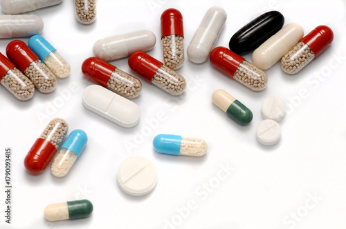 Pills Scattered on a White Background – A Visual Metaphor for Addiction and Health Risks