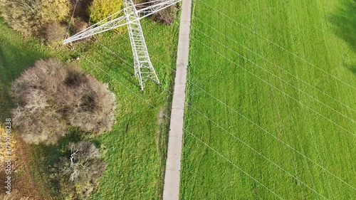 Aerial View of High Voltage Power Line Tower in Green Landscape