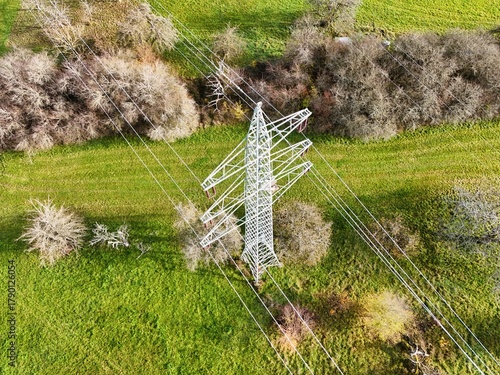 Aerial View of High Voltage Power Line Tower in Green Landscape