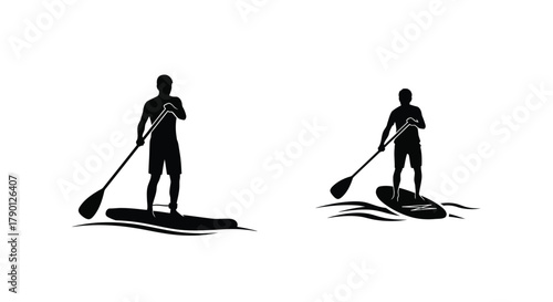 Silhouettes of two people stand up paddleboarding on dark water