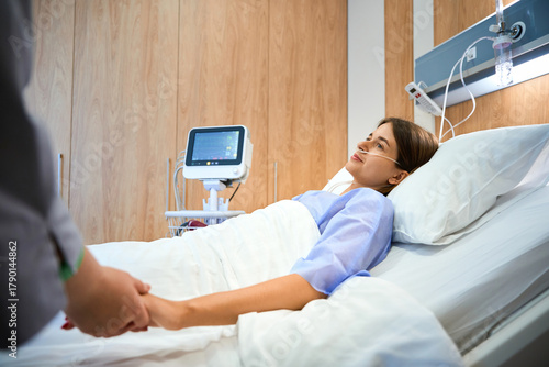 Nurse assisting patient with IV infusion while offering support