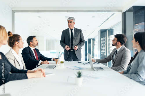 Executive leading business team meeting and brainstorming in office