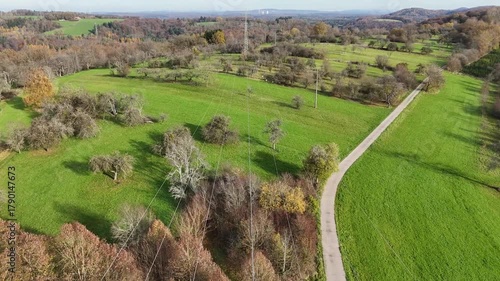 Aerial View of High Voltage Power Line Tower in Green Landscape
