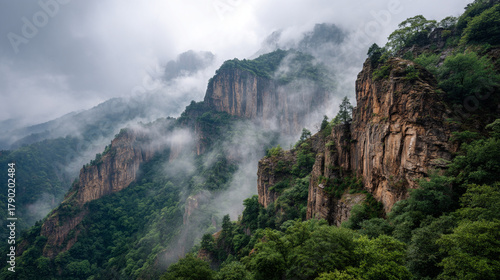 Landscape view of mountains covered in mist and lush green vegetation