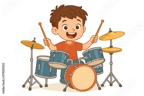 Happy young boy playing a full drum set with enthusiasm and smiling widely