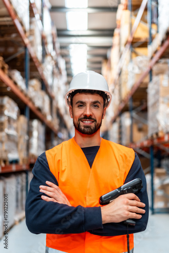 Warehouse worker standing in logistics facility with scanner