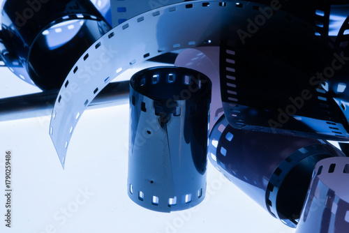 Film strip template with three blank or empty frames, developed 135 type or 35mm film placeholder on white, real film grain