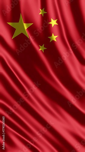 Waving Chinese national flag with golden stars closeup.