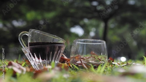 Drip coffee on the autumn morning grass