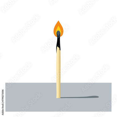 A burned-out matchstick lying in a straight line on a table, leaving a small trace of ash.