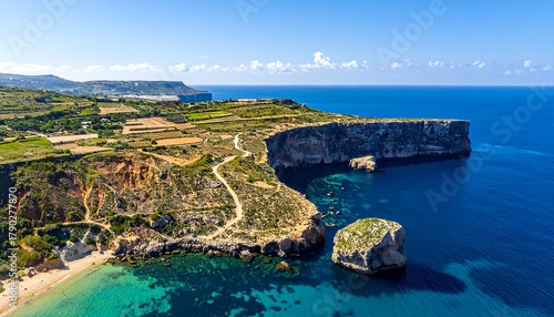 Aerial view of a scenic coastal landscape with azure waters and dramatic cliffs
