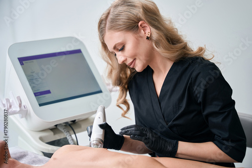 Cosmetologist doing microneedle lifting for man in aesthetic clinic