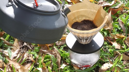 Drip coffee on the autumn morning grass
