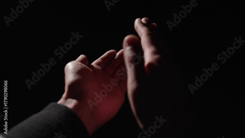 POV, close-up first person view stranger claps his hands on a black background. Close-up of men hands clapping.