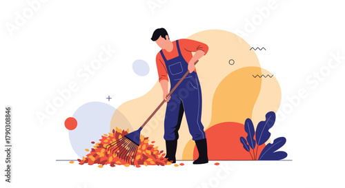 Man raking a pile of autumn leaves during the fall season.