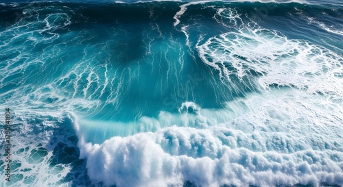 Fototapeta Naklejka Na Ścianę i Meble -  An aerial shot of a powerful blue and turquoise wave showing the beauty and power of the ocean.

