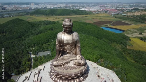 Aerial view of the Golden Buddha statue at Liudingshan Cultural Tourism Area in Dunhua City, Jilin Province, China. Massive golden statue overlooking Zhengjue Temple and facing the Changbai Mountain