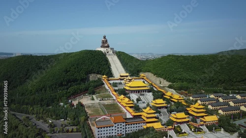 Aerial view of the Golden Buddha statue at Liudingshan Cultural Tourism Area in Dunhua City, Jilin Province, China. Massive golden statue overlooking Zhengjue Temple and facing the Changbai Mountain