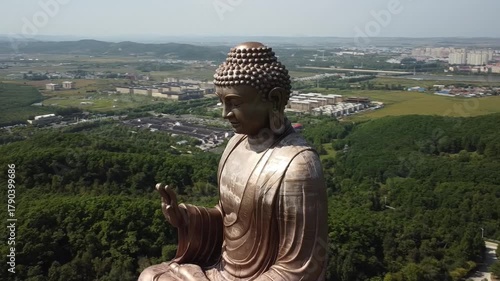 Aerial view of the Golden Buddha statue at Liudingshan Cultural Tourism Area in Dunhua City, Jilin Province, China. Massive golden statue overlooking Zhengjue Temple and facing the Changbai Mountain
