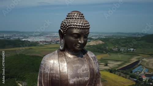 Aerial view of the Golden Buddha statue at Liudingshan Cultural Tourism Area in Dunhua City, Jilin Province, China. Massive golden statue overlooking Zhengjue Temple and facing the Changbai Mountain