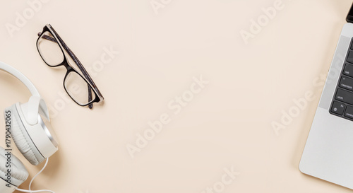 Fototapeta Naklejka Na Ścianę i Meble -  Laptop and stationery on beige workspace, top view with copy space