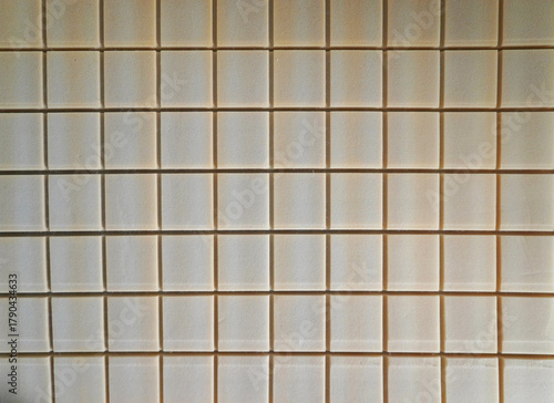 Wallpaper Mural The evenly spaced squares of the foam mattress form a geometric pattern against a soft beige texture. Torontodigital.ca