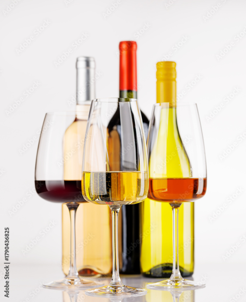 Naklejka premium Different wine bottles and glasses on white background