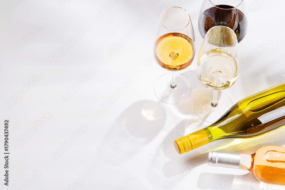 Fototapeta premium Different wine bottles and glasses on white background