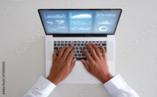 Professional businessman hands typing on laptop computer with financial data dashboard on screen. focused top view of work, technology, and business analysis