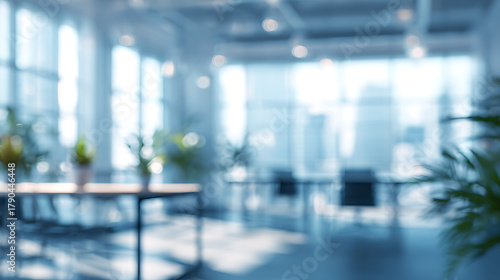 Soft focus office interior with plants and desks blurred background