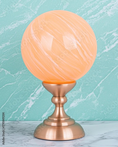 Elegant Peach Marble Sphere on Copper Stand with Textured Teal Background