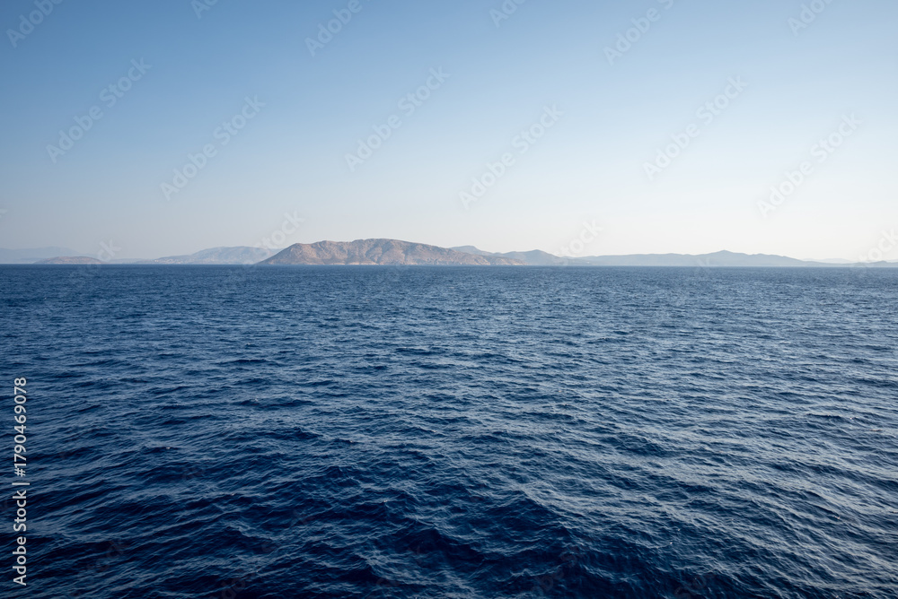 Fototapeta premium Tranquil Sea with Distant Island