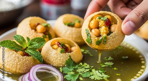 Golden Bites of Culinary Delight: A close-up shot of a tantalizing Indian street food known as pani puri, its crispy, golden shells filled with a vibrant medley of flavors. 