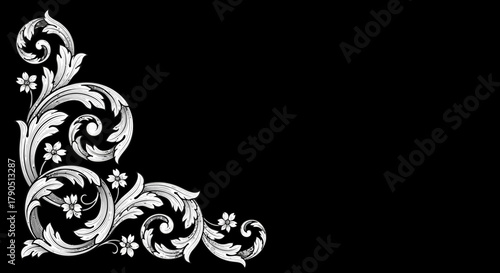 Ornate floral corner design in white on a black background.