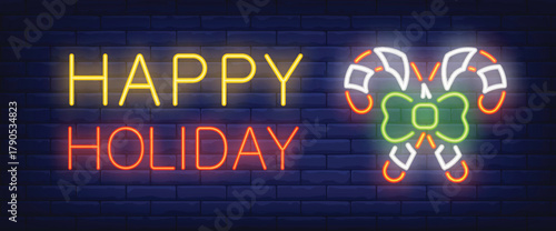 Art & Illustration of neon 'happy holiday' illustration with candy sticks beside on blue brick wall background