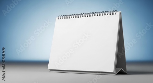 Blank spiral notebook template for calendar notes on an office desk
