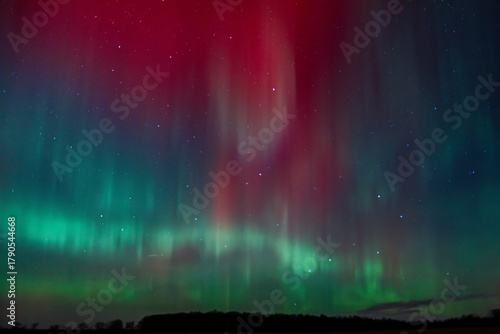Aurora Borealis over St. Croix County, Wisconsin on November 11, 2025. Red and green northern lights illuminate the night sky with the Big Dipper and North Star visible above the horizon.