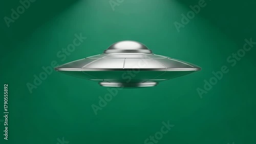 A sleek, metallic silver unidentified flying object ufo hovers in the center against a dark green, subtly lit background, evoking mystery extraterrestrial themes